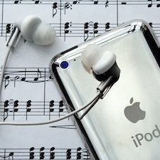 picture of iPod with headphones laying atop sheet music