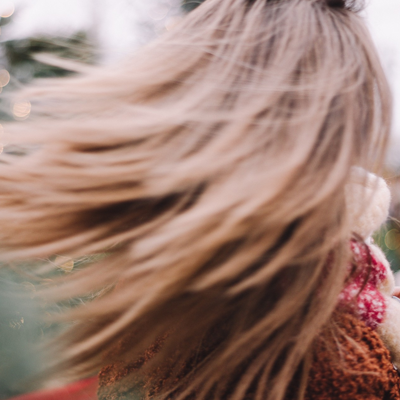Blonde woman's hair in motion with a blurred background