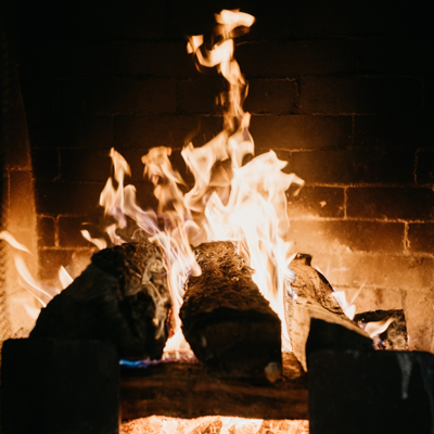 Brick fireplace with a blazing fire