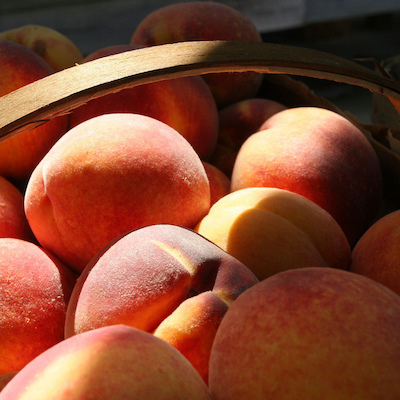 fresh peaches in a wooden basket