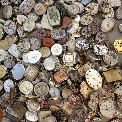 An overlapping pile of old watch faces