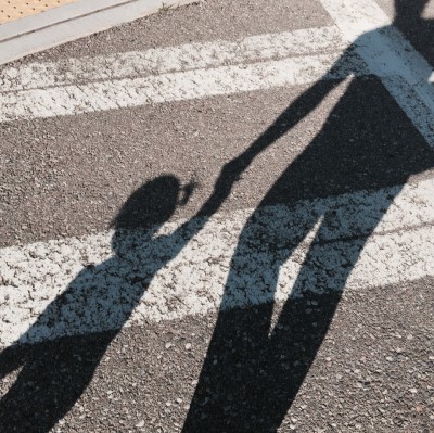 Shadow of people crossing the street