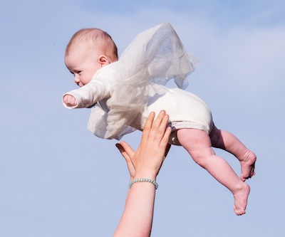 infant being thrown playfully into the air