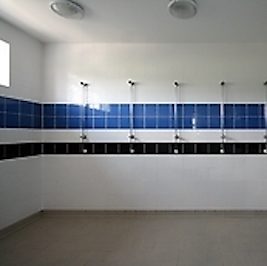 an empty, white, blue and black communal shower