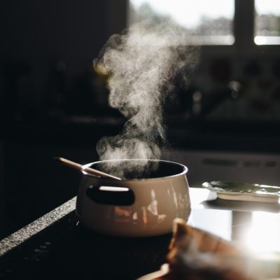 A steaming pot sits on the stove
