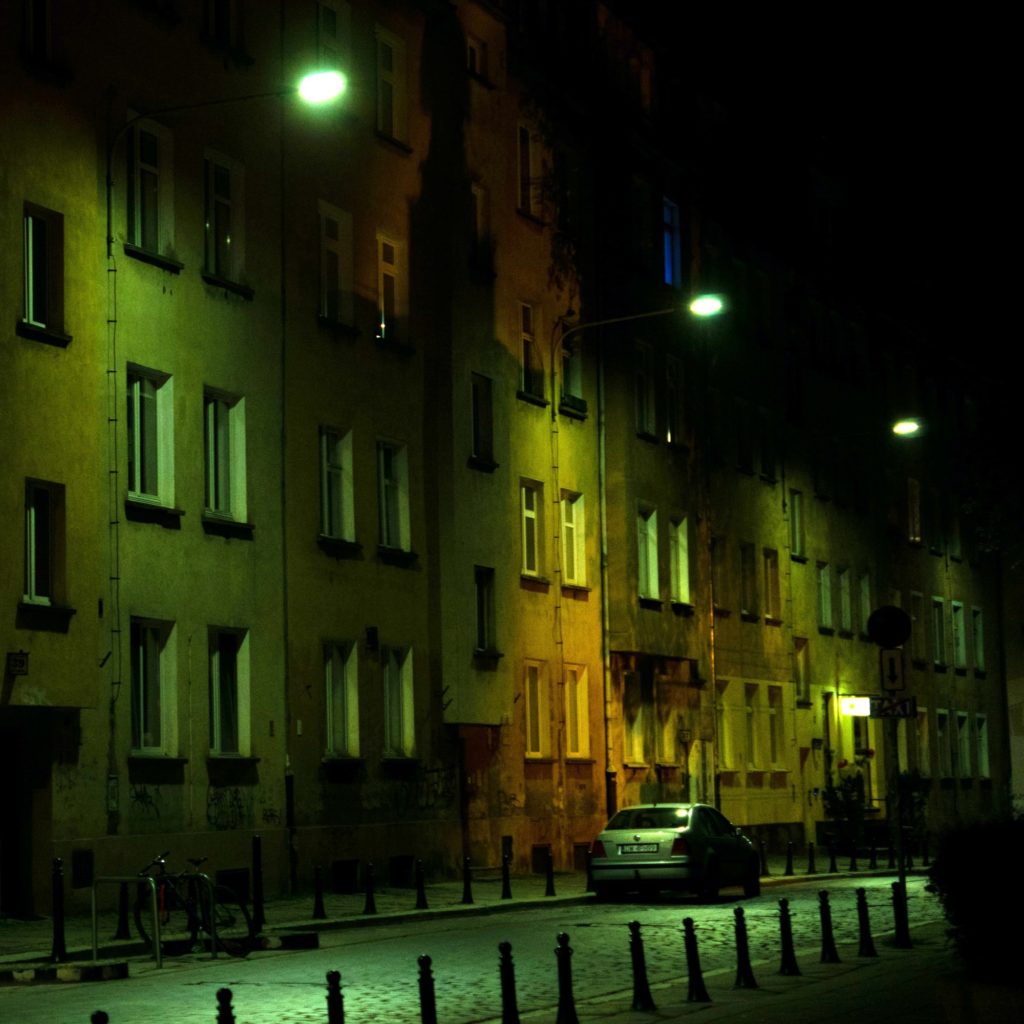 Photo of apartment buildings at night, in shadow and light