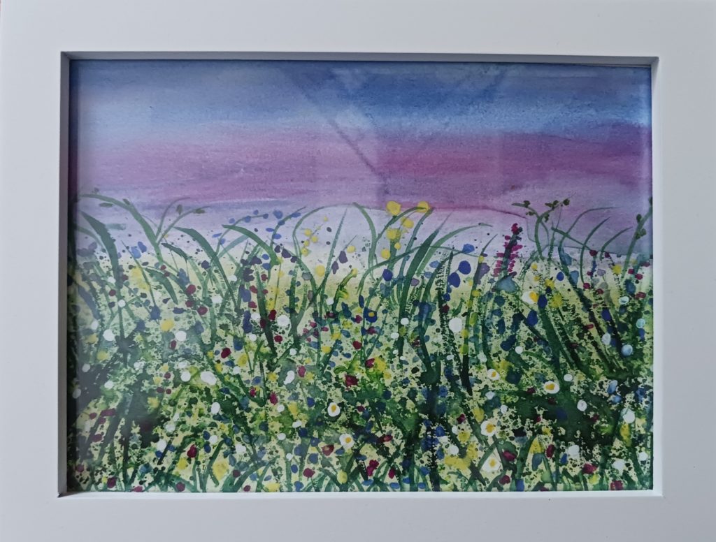 Close-up of a watercolor painting of a meadow with tall grasses and wild flowers